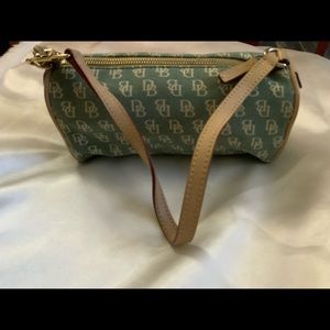 Small signature Dooney & Bourke Barrell bag. Blue-ish-greenish grayish in color.